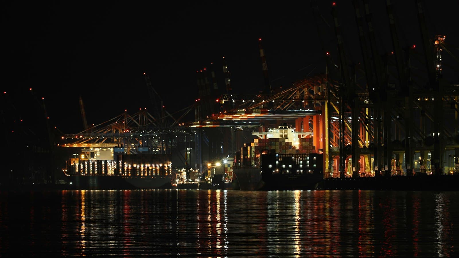 Port cranes illuminated at night