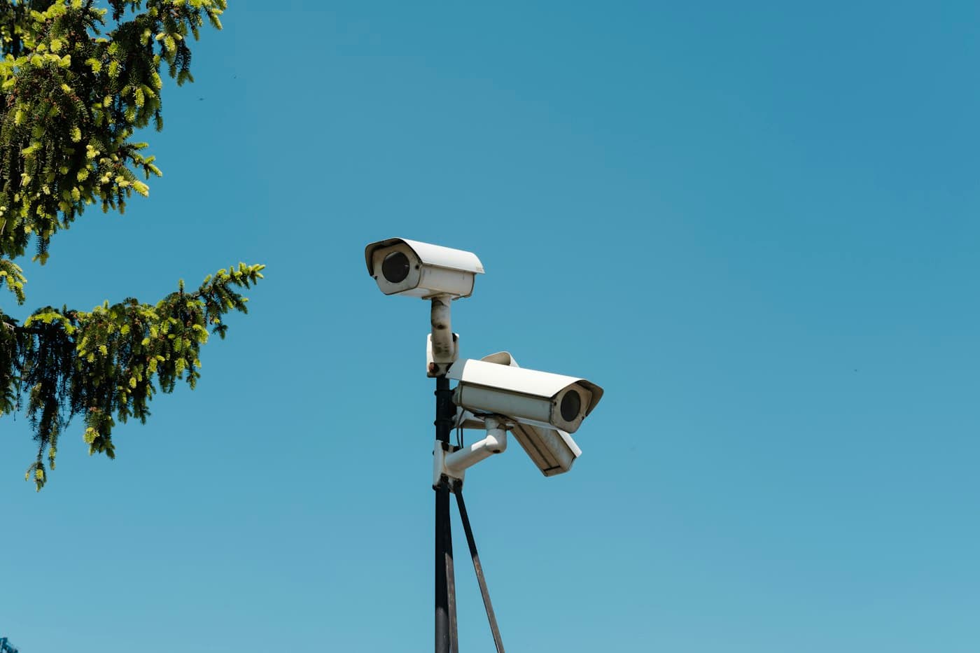 Security cameras against a blue sky